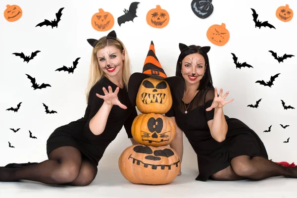 Halloween.Portrait of two young woman in black witch halloween costumes on party. — Stock Photo, Image