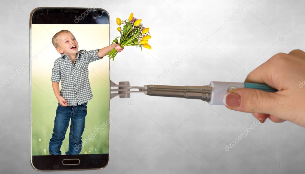 Spring surprise. The boy gives a bouquet of tulips through the phone screen. The concept of the holiday.