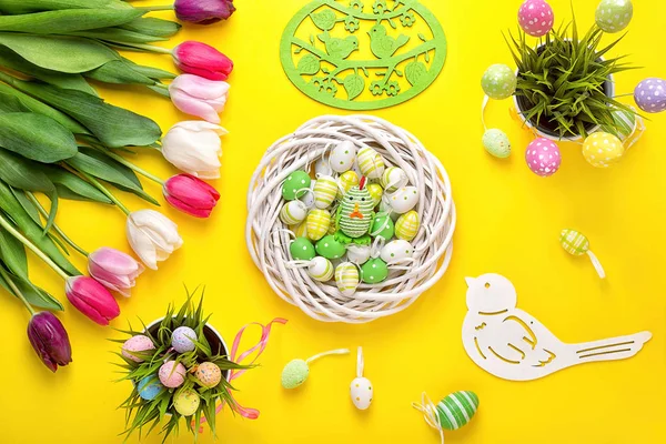 Easter eggs with colorful tulips on wooden background.Easter holiday concept. Easter decor.