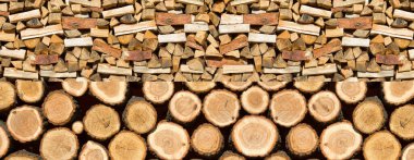 Preparation of firewood for the winter. Firewood background. Background of dry chopped firewood. Wooden background.Stacks of Firewood. clipart