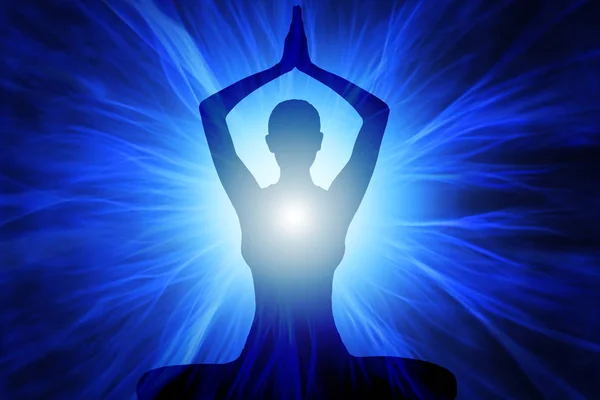 Menselijke silhouet in de houding van de yoga en meditatie — Stockfoto