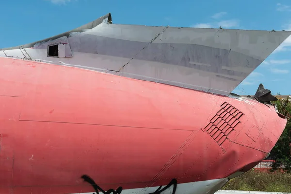 Plane fuselage wreckage sitting on the ground