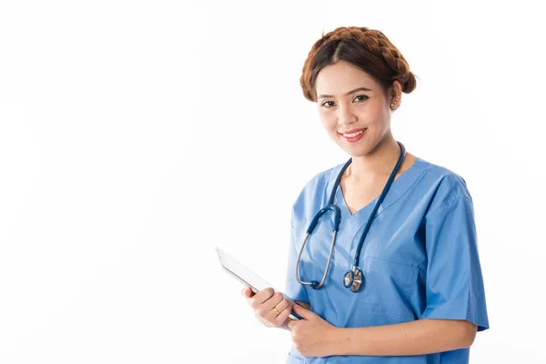 Female Asian nurse using a digital tablet & wearing a blue coat