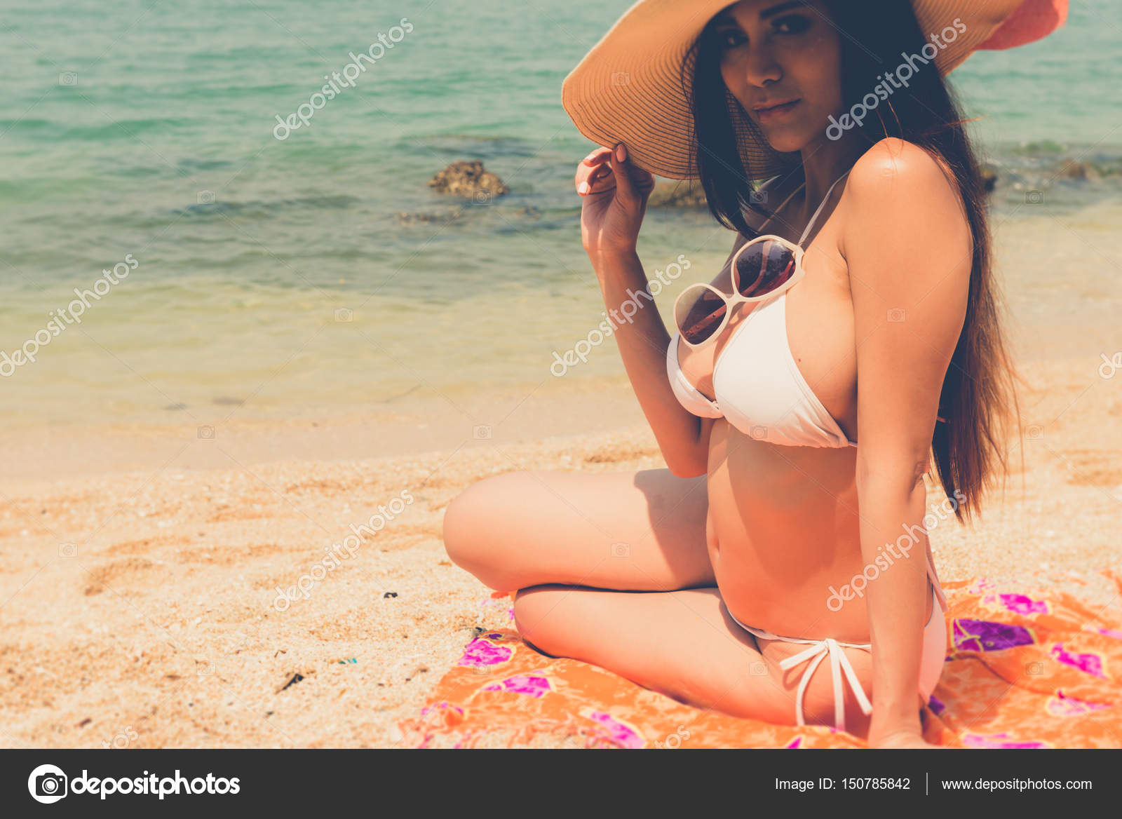 Beautiful attractive large breast asian bikini woman sitting on
