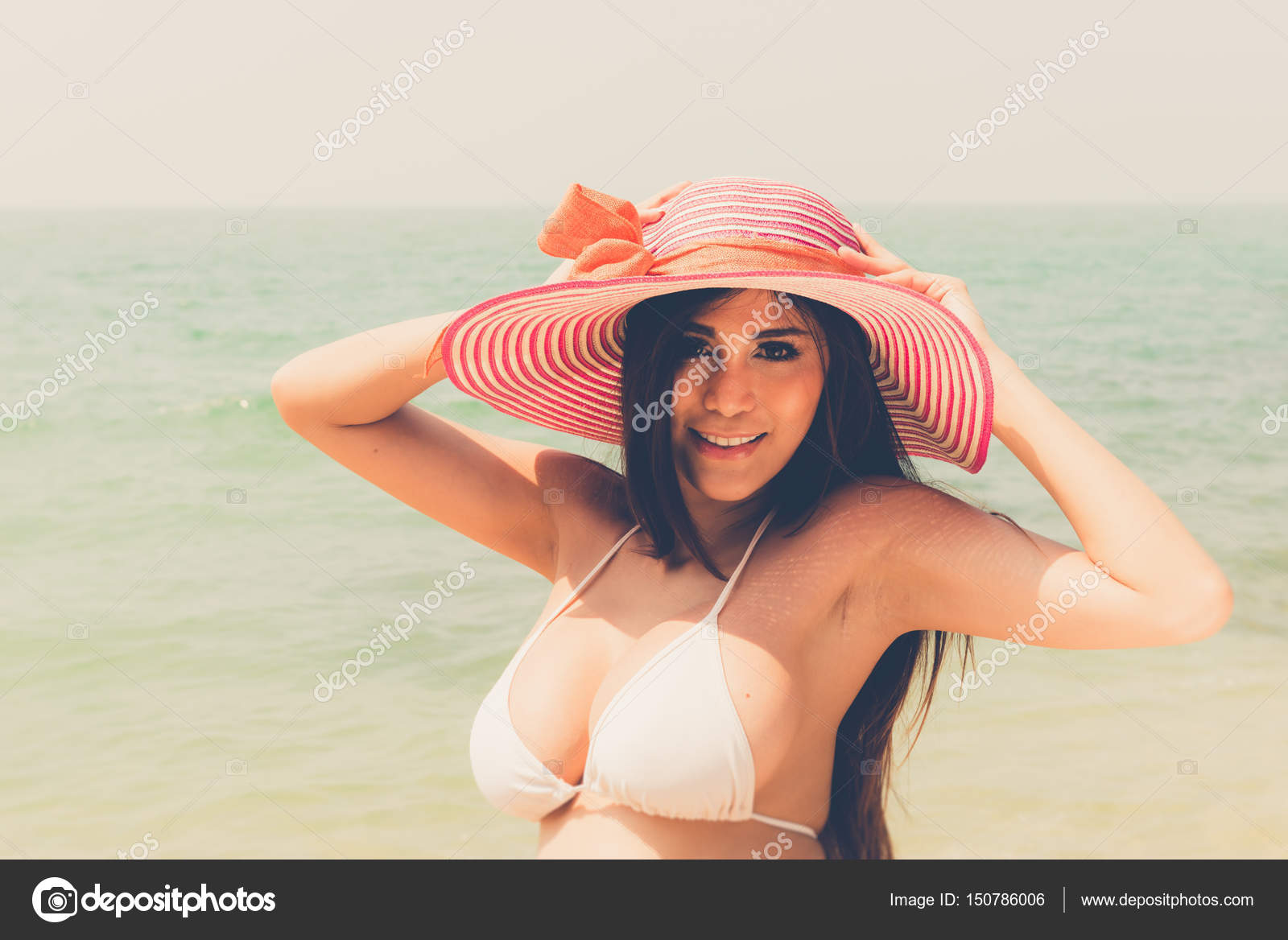 Beautiful attractive large breast asian bikini woman posing sexy Stock  Photo by ©sasilsolution 150786006