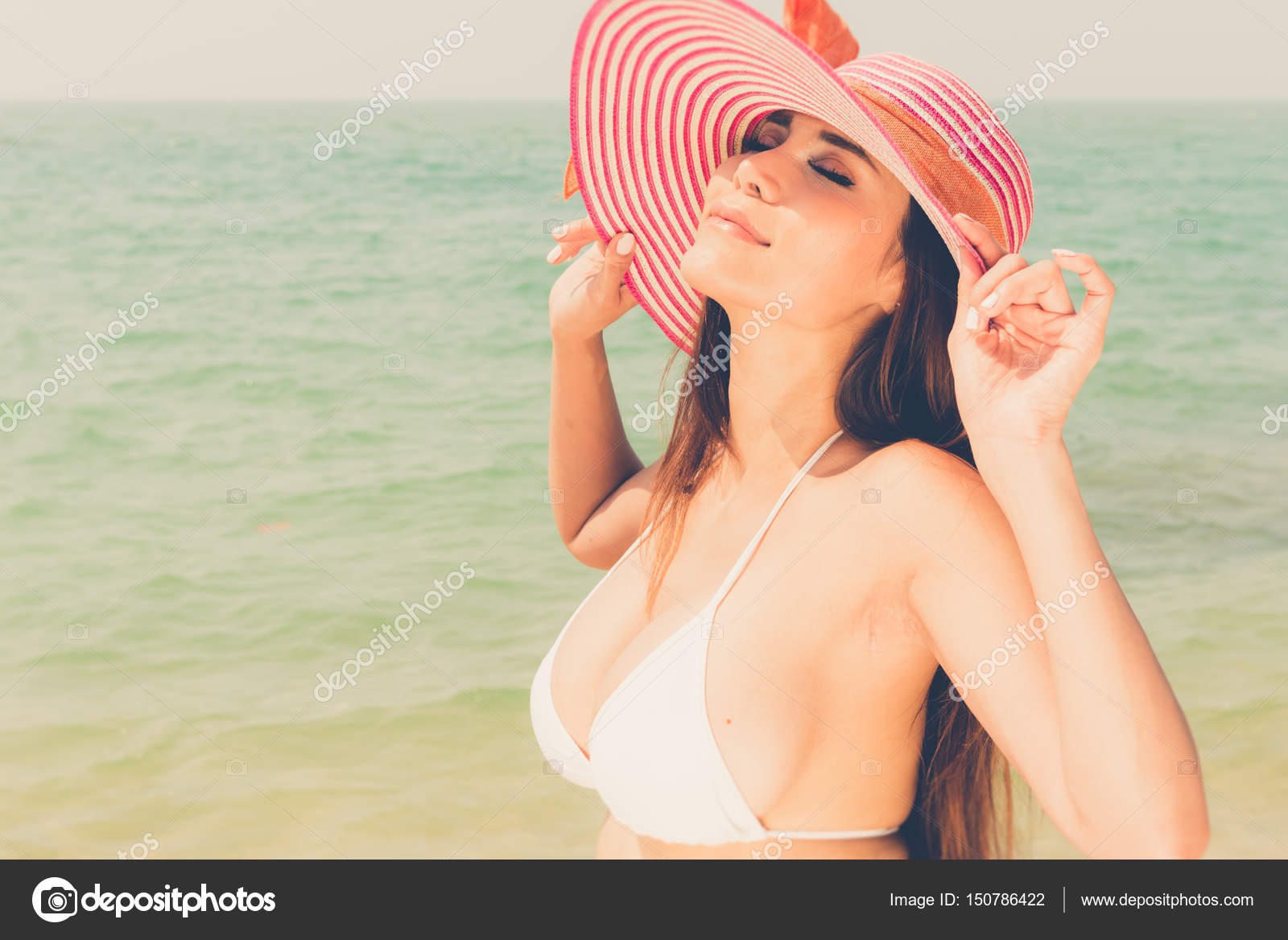 Beautiful attractive large breast asian bikini woman posing sexy Stock  Photo by ©sasilsolution 150786422