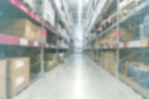 Blur background large indoor warehouse with high racks and produ — Stock Photo, Image