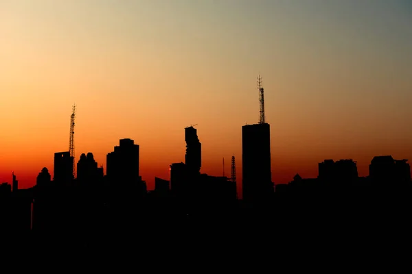 silhouette of urban city sunset with tall sky scrapers, financia