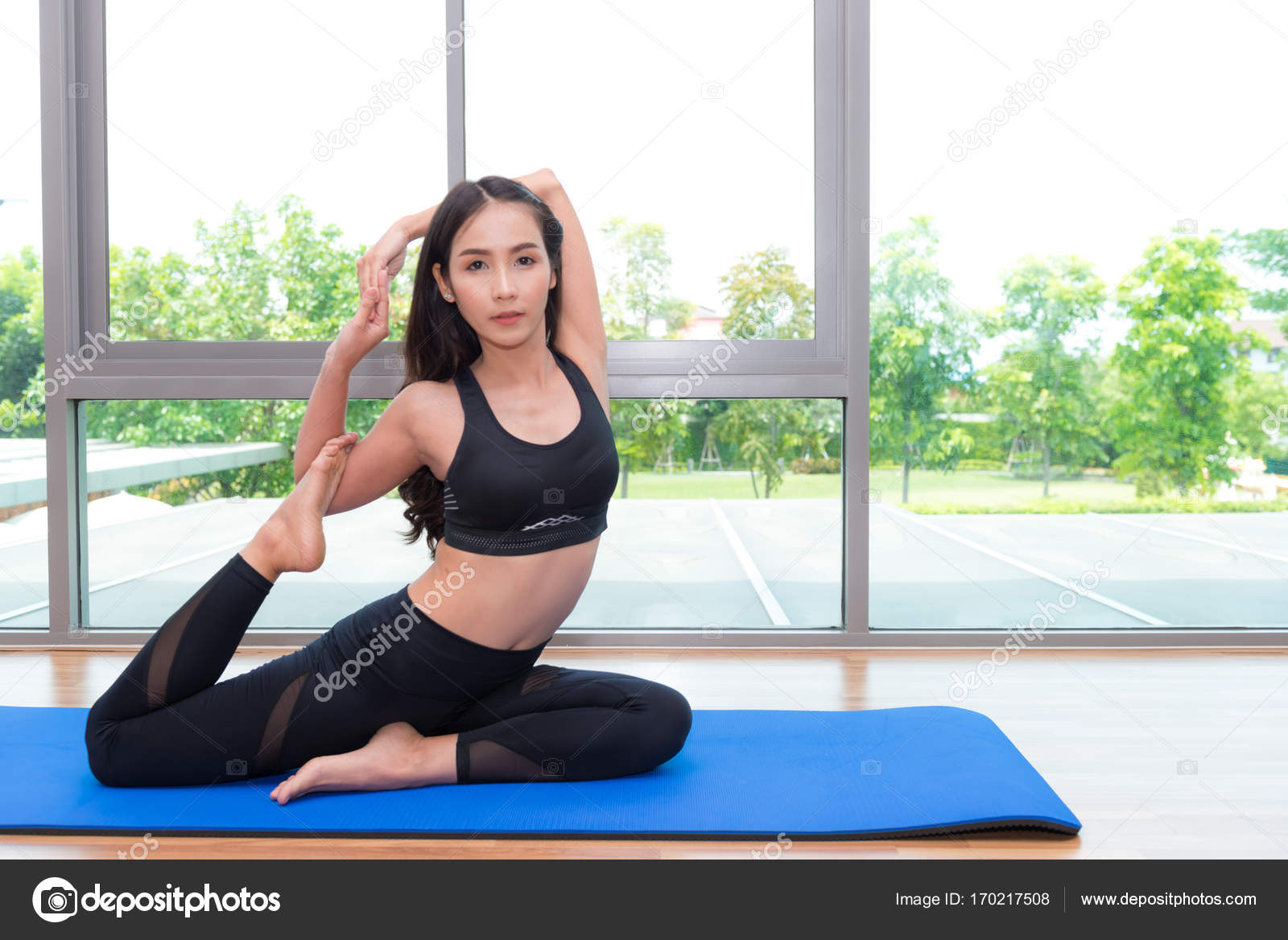 Beautiful young fit asian woman doing yoga. Stock Photo by ©sasilsolution  170217508