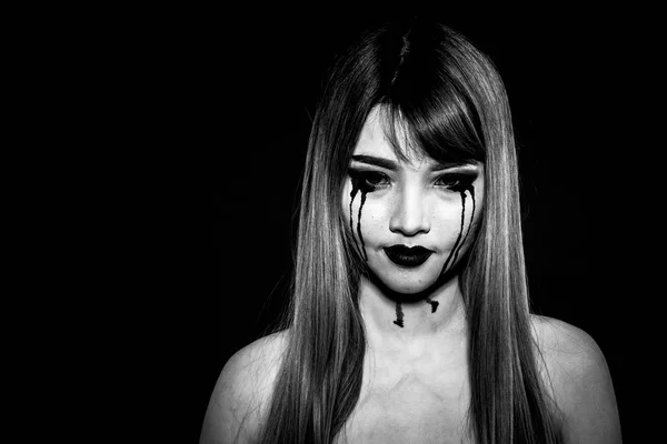 Angry enrage Asian woman in black and white isolated in black ba