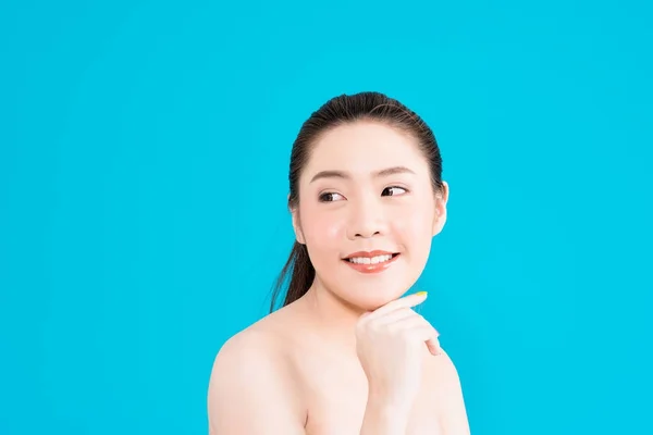 Giovane donna asiatica pensando isolato su sfondo blu . — Foto Stock