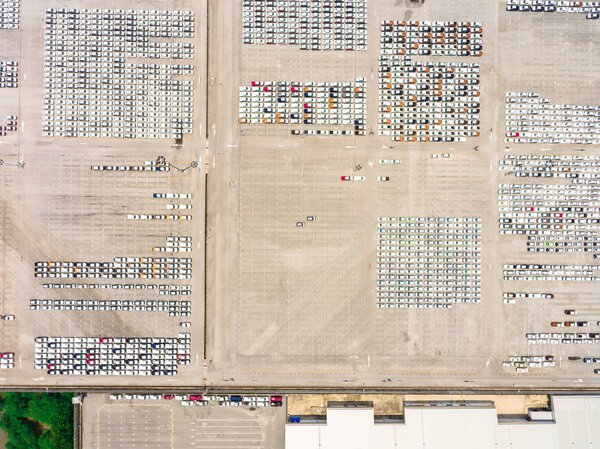 Large empty car factory car park, aerial view top down. 