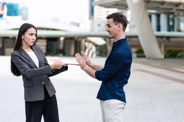 Sale woman trying to sell insurance to potential male client. Beautiful young sale woman trying hard to sell insurance to handsome young rich white male. Taken outdoor. Confident sale woman concept.