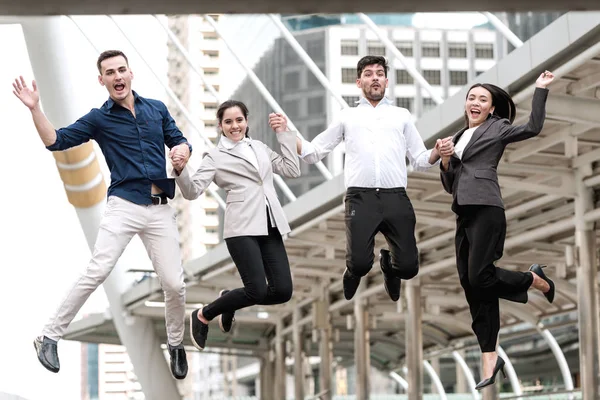 Young business team jumping for huge celebration of successful t