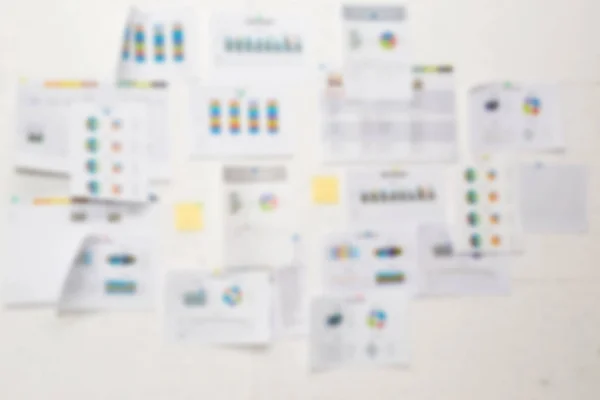 Blur background of white board with many business papers and rep