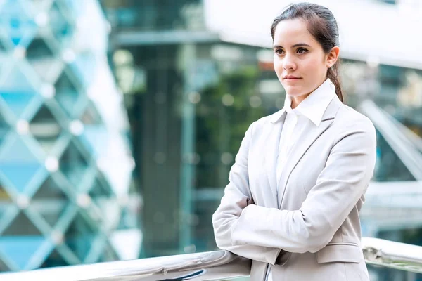 Portrait of confident business woman. Young professional career business woman standing  outside looking confident. Taken outdoor with natural lights. For young woman leadership, career path concept.