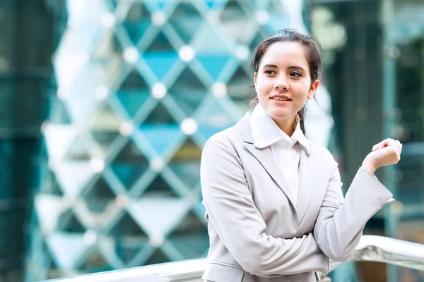 Portrait of confident business woman. Young professional career business woman standing  outside looking confident. Taken outdoor with natural lights. For young woman leadership, career path concept.