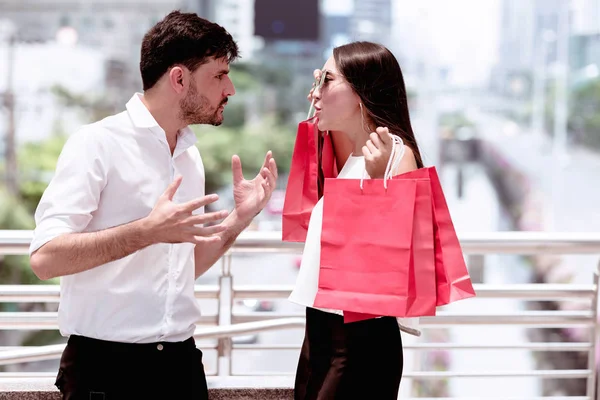 Couple argue after a hard day of huge sale shopping in asian cou