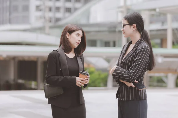 Young generation business team not working together concept. Young business intern Asian woman having very serious fight and arguments with her Asian female manager, dramatic expression. Medium shot.