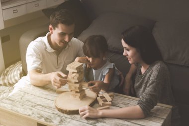 Annem ve babam oynamak puzzle oyunu oturma odasında kendi kızı ile birlikte. Aile eğlenceli zaman kavramı.