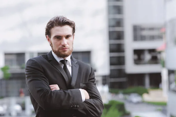 Confident young business man in black tie portrait.