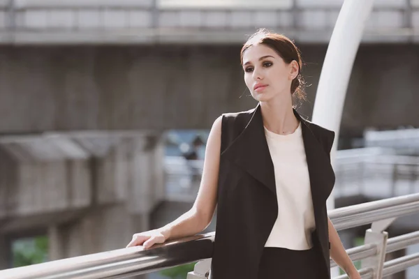 Confident young business woman in smart office dress portrait.