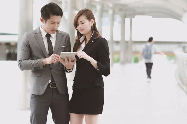 Young generation business team concept. Young business intern woman getting final coach by her male manager before going to meet client in office for the first time. Taking in business district.