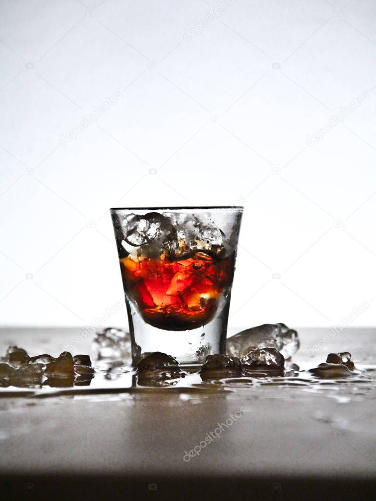 Still of a little liquor glass with background light.