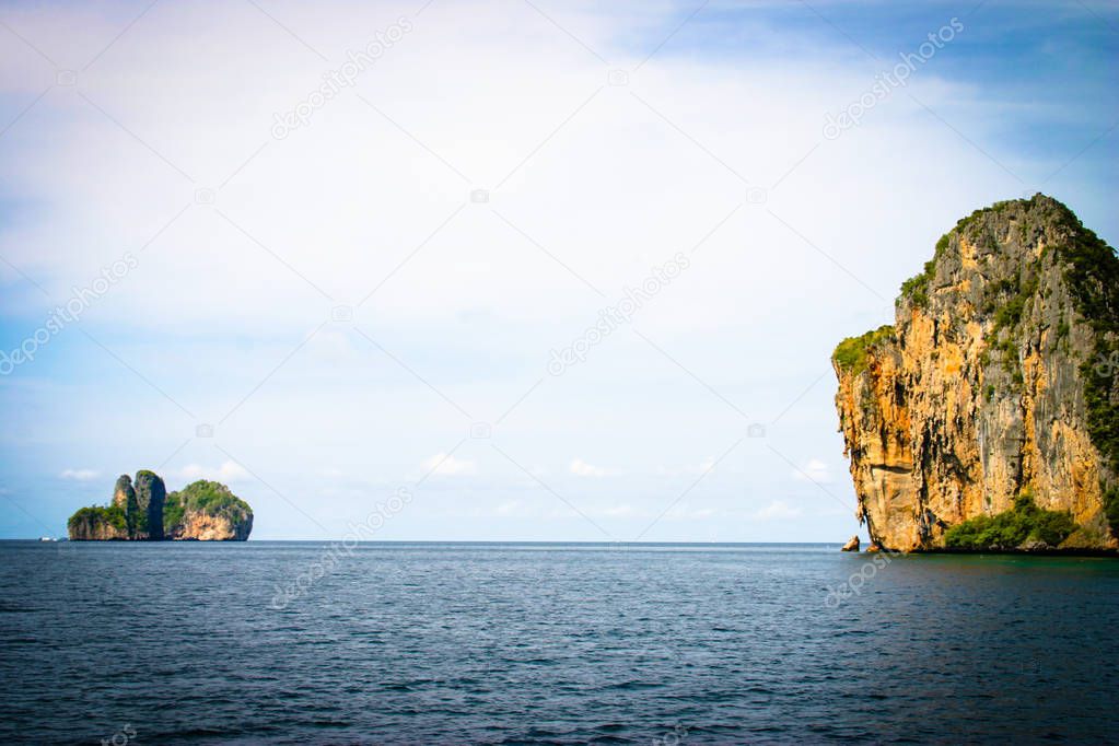 Great and large rocks in the ocean. Small islands with green for
