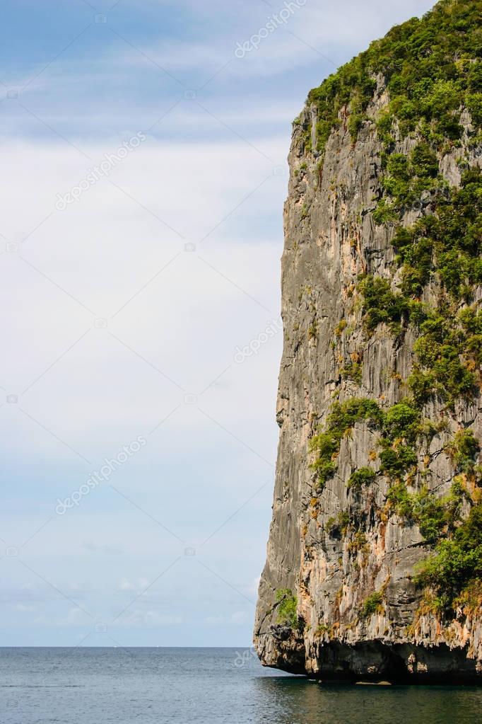 Great and large rocks in the ocean. Small islands with green for