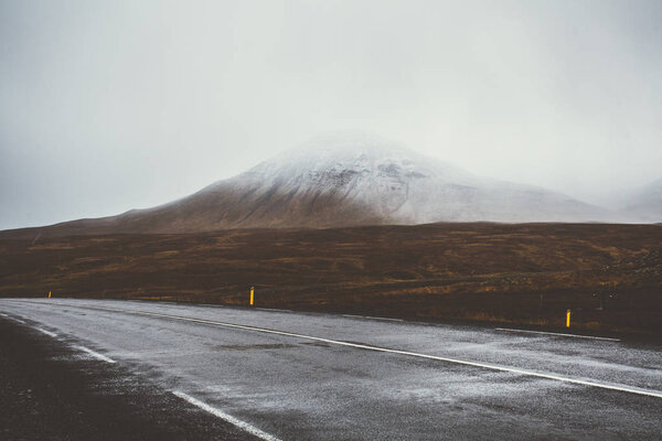 Empty road in front of a mountain range with fog. Lovely landsca Stock Photo