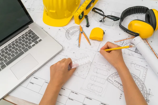 Entregar planos de construcción con casco amarillo y herramienta de dibujo —  Fotos de Stock