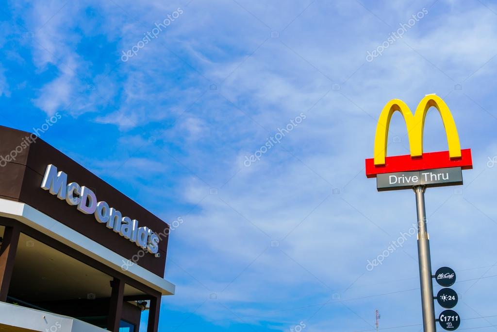 Khonkaen Province, Thailand - December 20, 2015 : McDonalds logo on blue sky McDonald's Corporation is the world's largest chain of hamburger fast food restaurants.