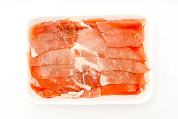 Folie von rohem Schweinefleisch auf weißem Hintergrund . — Stockfoto