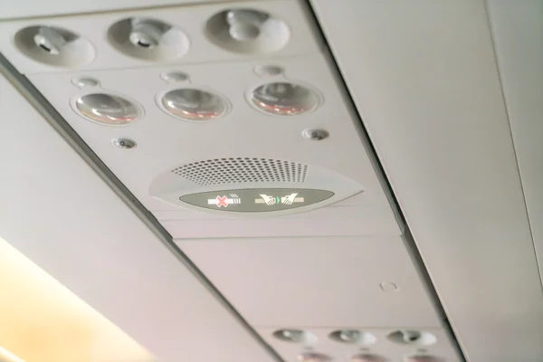 No smoking sign and seat belt sign on the airplane . — Stock Photo, Image