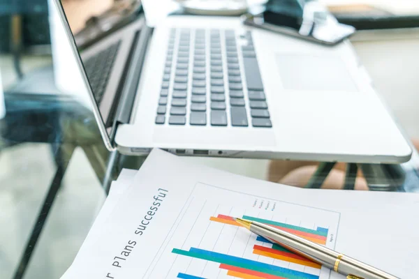 Financial charts on the table with laptop . — Stock Photo, Image