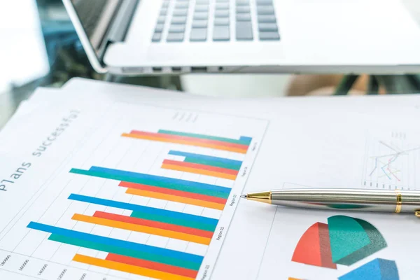 Financial charts on the table with laptop . — Stock Photo, Image