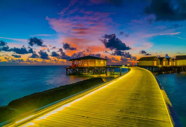 在热带马尔代夫岛日落时美丽的水上别墅 — 图库照片