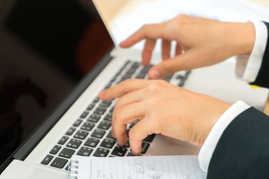 Kapalı toplantıda laptop ve mali grafikleri kullanarak iş adamları