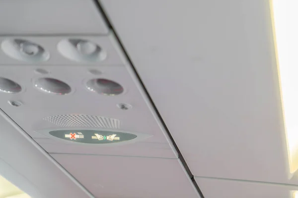 No smoking sign and seat belt sign on the airplane . — Stock Photo, Image