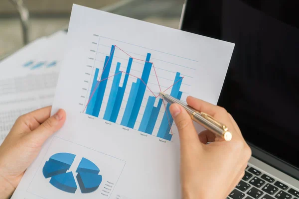 Business woman hand with Financial charts and laptop on the tabl — Stock Photo, Image