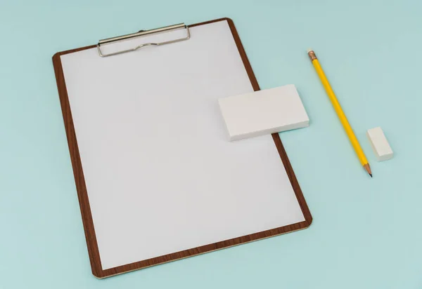 Clip board, paper,pencil  and business card on blue background . — Stock Photo, Image