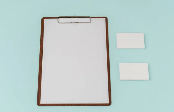Clip board, paper and business card on blue background . — Stock Photo, Image