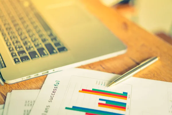 Financial charts on the table with laptop  ( Filtered image proc — Stock Photo, Image