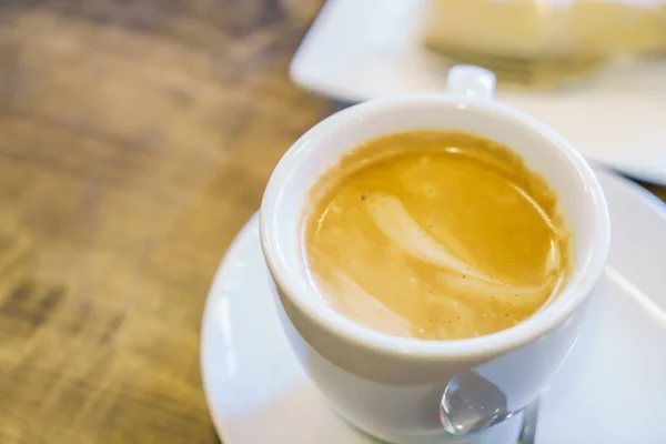 Vita kaffekoppen på bordet i café — Stockfoto