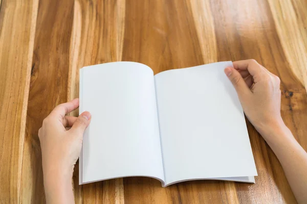 Hands open book on wood table . — Stock Photo, Image