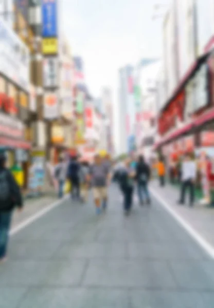 Abstract blur Crowd of anonymous people walking on busy street