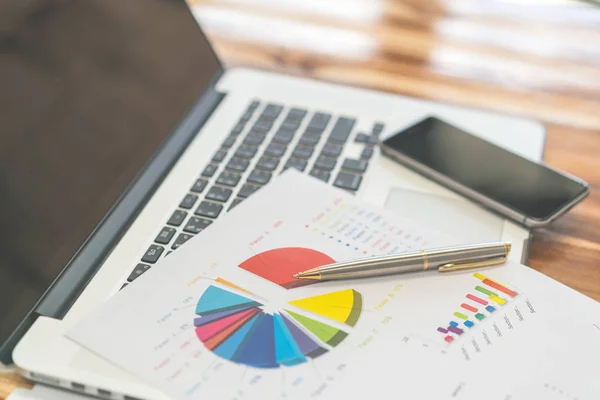 Financial charts on the table with laptop . — Stock Photo, Image