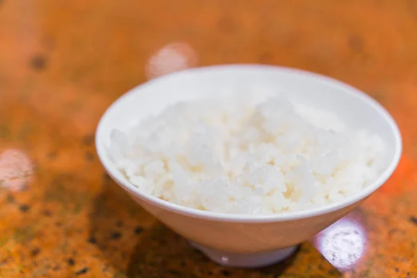 Arroz branco cozido no vapor em xícara na mesa  . — Fotografia de Stock