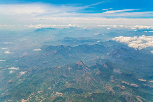 Montanhas sob nuvens. Vista do avião  . — Fotografia de Stock